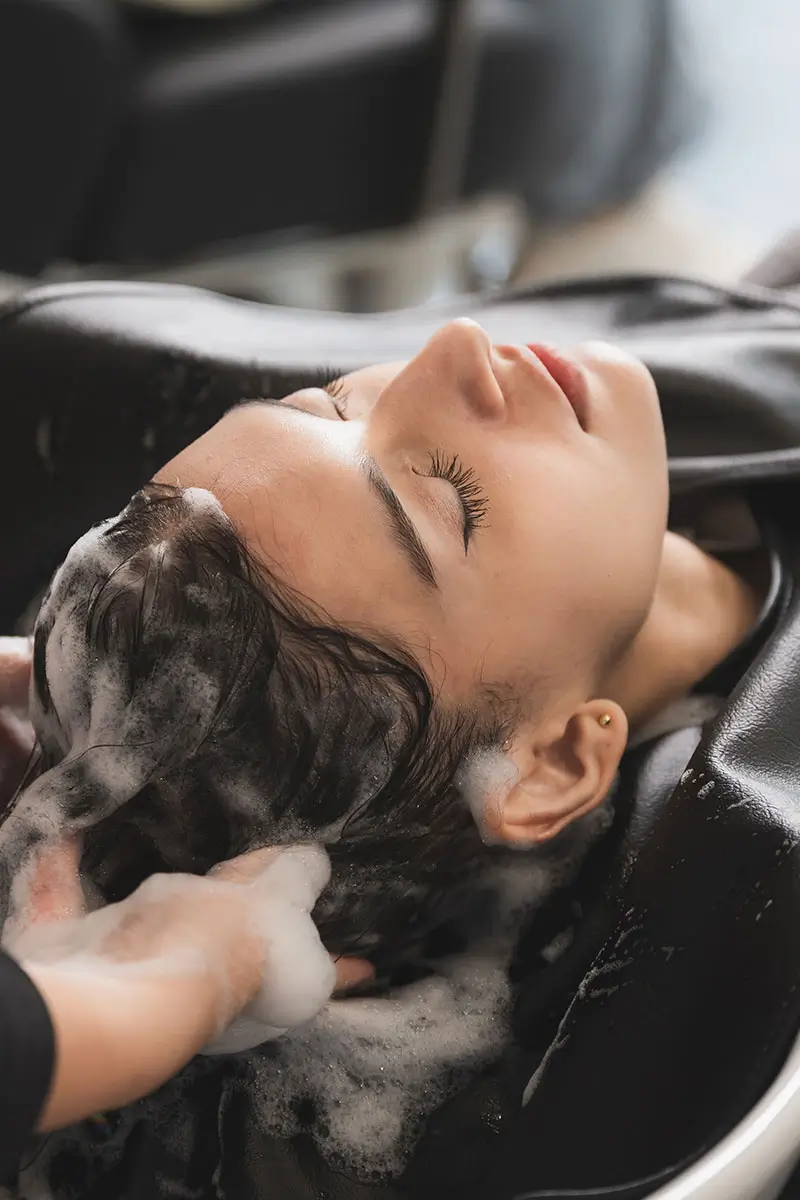 hairdresser washing client's hair